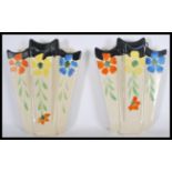 A pair of earl 20th Century Art Deco ceramic hand painted wall pockets, hand painted floral