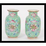 A pair of 19th century Chinese miniature Canton Enamel vases hand decorated with traditional