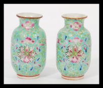 A pair of 19th century Chinese miniature Canton Enamel vases hand decorated with traditional