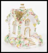 A 19th century Large Staffordshire pastel burner in the form of a house with hand painted