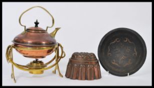 A 19th century copper and brass spirit kettle along with a Victorian copper jelly mould and a bronze