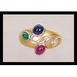 An 18ct yellow gold ruby, emerald, Sapphire and diamond ring in the Art Nouveau manner having