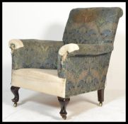 A Victorian mahogany Howard style armchair upholstered in a William Morris type fabric, raised on