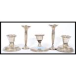 A group of five silver hallmarked filled candlesticks to include a pair of stub candlesticks, a pair