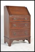 An Edwardian mahogany inlaid bureau desk having fall front slope with appointed interior set over