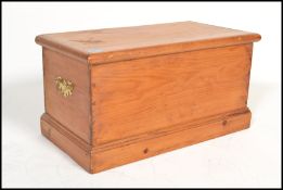 A 19th century Victorian pine blanket box coffer chest having brass drop handles with bat wing