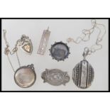 A group of silver hallmarked items to include a ingot, pocket watch case, fob, locket pendant, and