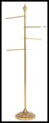 An early 20th century brass shop valet stand having four tubular valet poles. Measures 74 cm x 40 cm