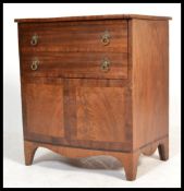 A 19th century mahogany bow front commode chest having French kick legs supporting bow front body