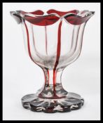 A 19th century Bohemian glass goblet vase having a cranberry red glass dash raised on scalloped base