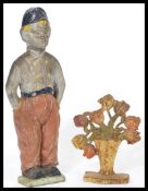 Two early 20th century 1930's cast metal painted door stops. One in the form of a a floral spray and