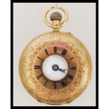 A hallmarked 18ct gold half hunter pocket watch. The white enamel face having a Roman numeral