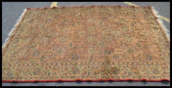 A mid 20th Century woollen floor rug on cream  ground decorated with colourful flowers throughout.