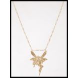 A hallmarked 9ct gold pendant necklace in the form of a fairy set to a 9ct gold Singapore link