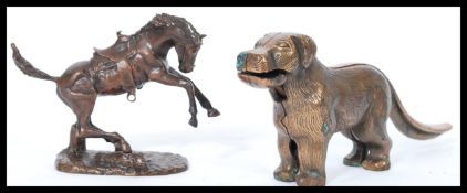 A vintage 20th century bronze figurine of a rearing horse with saddle along with a cast metal