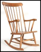 A 20th century contemporary antique style windsor rocking chair on sleigh runners with shaped