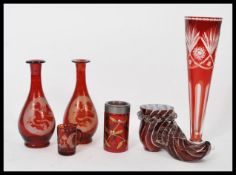 A good group of 19th century Bohemian cranberry glass to include a shoe, tall faceted vase, pair