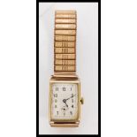 A vintage hallmarked 9ct gold square faced watch by Vertex with floral engraving to the case. The