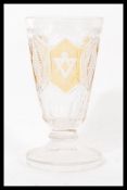 A 19th century Bohemian glass Masonic goblet raised on a circular foot with faceted and coloured