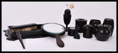 A collection of vintage 20th century ebony beauty dressing table set items to include tray,