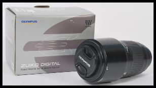 A Zuiko digital four / thirds zoom camera lens 70-300mm complete in original box