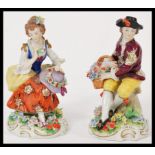 A pair of Sitzendorf porcelain figures of a gentleman holding a basket of flowers and a lady with