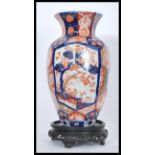 A 19th century Japanese Imari vase having hexagonal panels to the body with tapered neck and