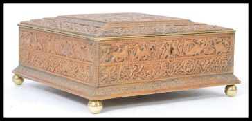 An early 20th century Arts and Crafts copper box decorated with scenes of figures and intricate