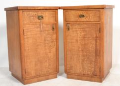 A pair of early 20th century, circa Edwardian maple wood bedside cabinets. Each with single door