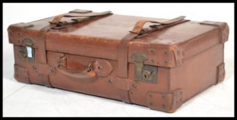 A good early 20th century leather ( believed pig ) suitcase with secure lever brass locks ( fully