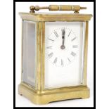 A square early 20th century brass cased carriage clock having a white enamel face with Roman numeral