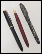 A group of three vintage fountain pens having 14k gold nibs comprising of a Burnham, Waterman's