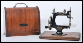 A vintage early 20th child's miniature sewing machine by Lead of cast iron and chrome construction