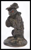 A 19th century bronze matchstriker modelled as a monkey bandsman playing the symbols having red