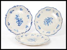 A set of three 19th century French Faience plates having hand painted blue and white decoration with