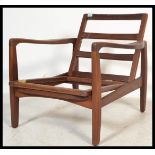 A vintage retro 20th century teak lounge chair of danish influence having a wooden frame. Measures