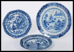 A group of three 19th century Chinese hand painted blue and white plates having scenes of