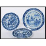 A group of three 19th century Chinese hand painted blue and white plates having scenes of