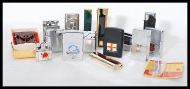 A collection of vintage cigarette lighters to include Ronson, Penguin, faux shagreen etc. Please see