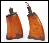 A pair of 19th century horn powder flasks in the form of gun stocks. Please see images.