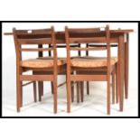 A mid 1970's Scandart teak wood dining room suite comprising an extending table raised on tapering