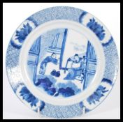 An early 18th century Chinese blue and white hand painted plate depicting courting scenes having