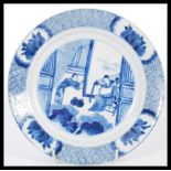 An early 18th century Chinese blue and white hand painted plate depicting courting scenes having