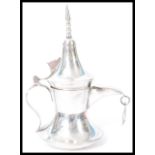 A sterling silver miniature model of a Dallah coffee pot having shaped handle and spout with