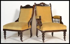 A pair of Victorian mahogany ladies and gentleman's salon armchairs being raised on ring turned legs