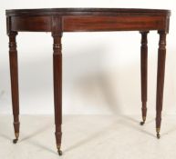 An 18th century George III mahogany tea table being raised on turned legs with shaped frieze