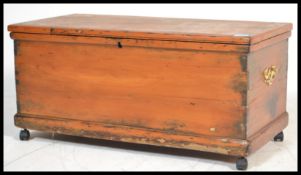 A Victorian 19th century pine blanket box of small proportions raised on castors having panel body