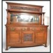 A large Victorian solid oak Arts & Crafts mirror back sideboard in the manner of Liberty & Co. The