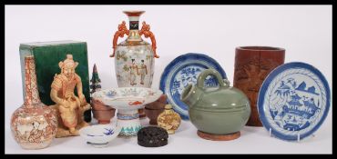 A group of Oriental homeware to include Chinese and Japanese ceramics and stone ware , carved wooden