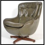 A 1970's retro swivel egg chair - armchair being raised on a teak 4 prong swivel base, the chair